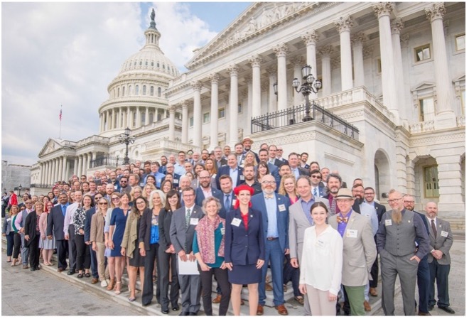 A group of brewers, brewery owners, employees, and state guild representatives from the Brewers Association stand on Capitol Hill in Washington, DC (Photo Credit: Brewers Association)
