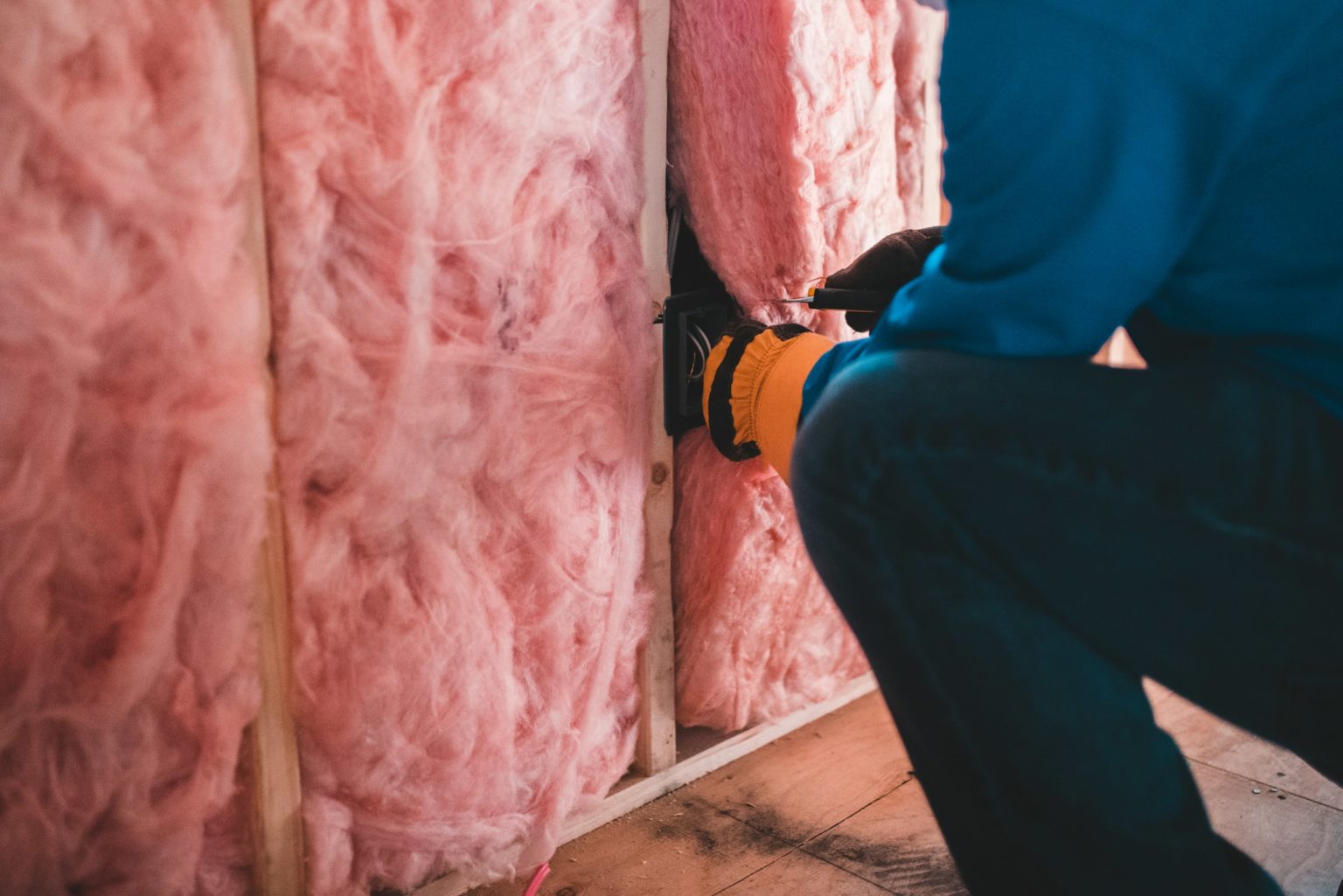 Person installing insulation.