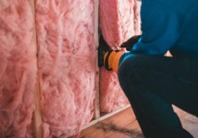 Person installing insulation.